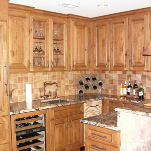 Kitchen with wooden cabinets by Home Tech Construction Services